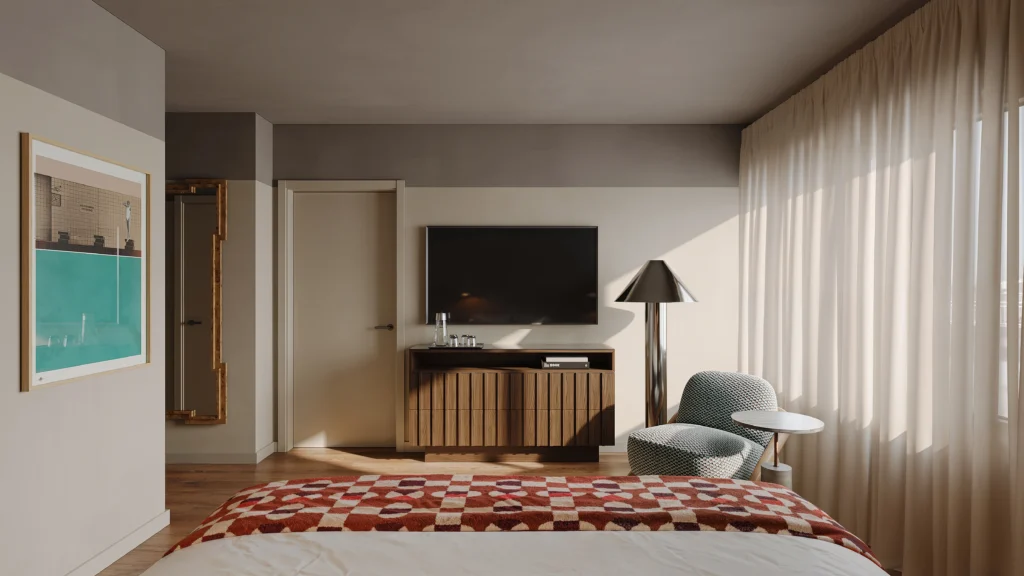 Modern hotel room with wall-mounted TV, wood cabinet, lounge chair, and sheer curtains in daylight